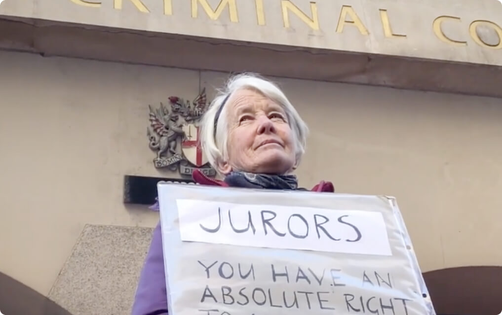 Trudi holding a sign outside court